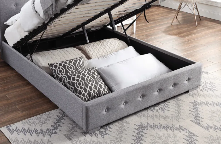 A grey ottoman bed is opened up to show ample storage space underneath, one of the key reasons to choose an ottoman bed.