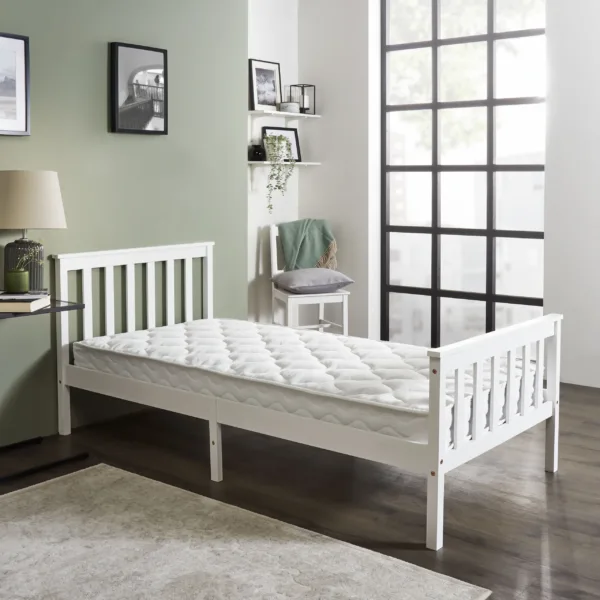 White wooden bed with sprung bonnell mattress