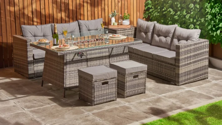 A modern rattan garden furniture set with tables and chairs aplenty.